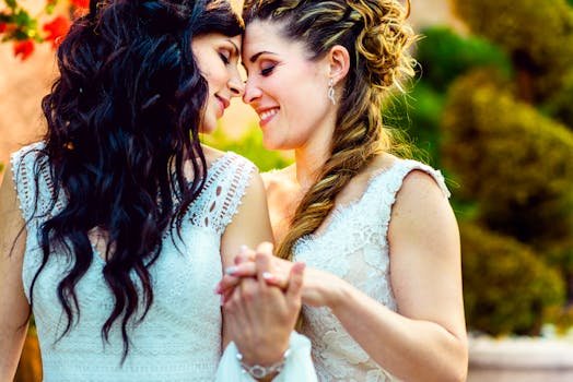 Beautiful lesbian couple embracing joyfully at their outdoor wedding ceremony, brimming with love.