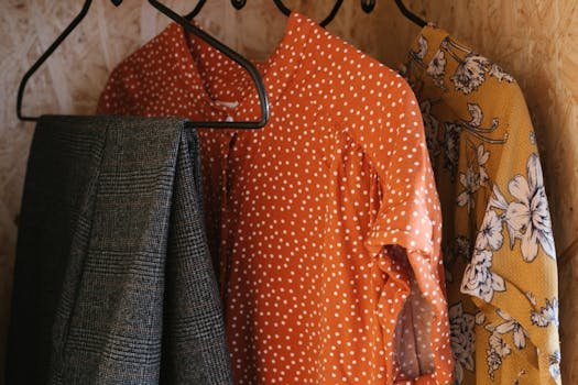 Vibrant clothes hanging on metal hangers showcasing diverse patterns and styles.