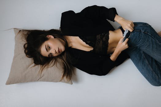 Fashion portrait of a woman lying down in casual attire, shot in studio